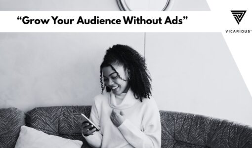 African digital content creator smiling while engaging followers on a mobile phone without paid promotion.