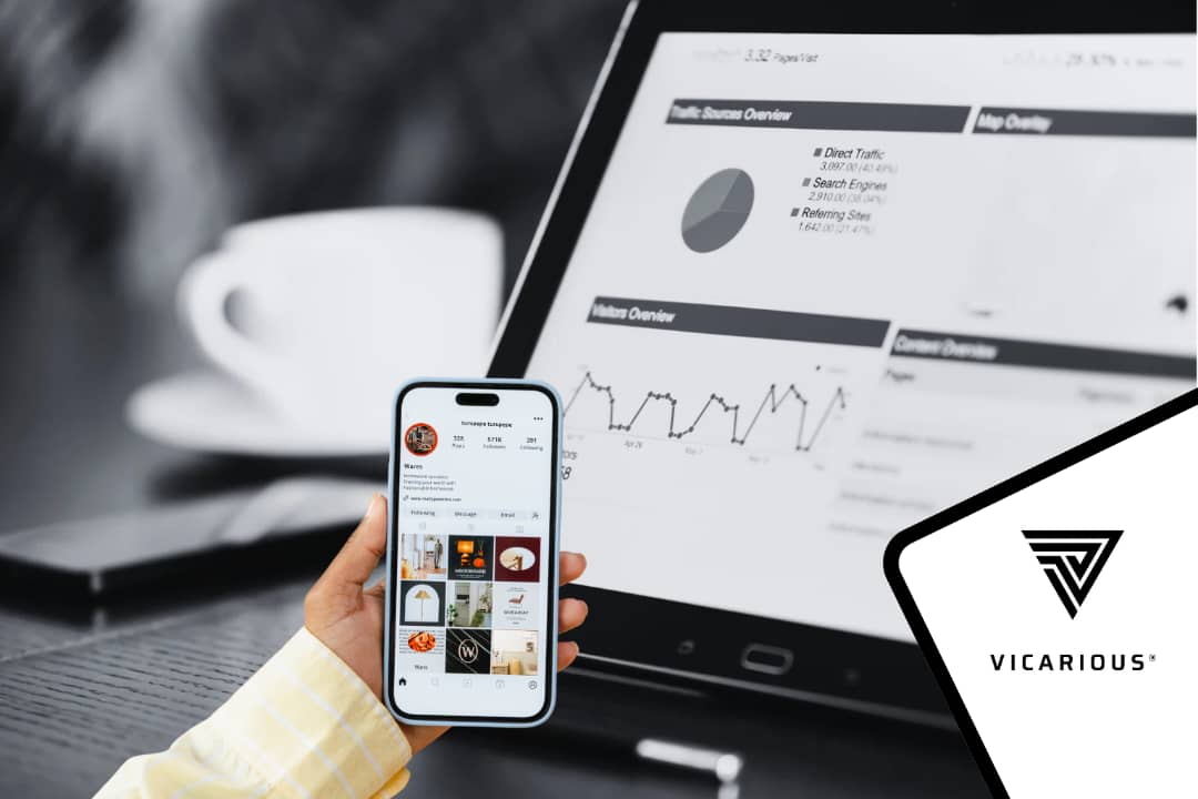 A Nigerian content creator analyzing Instagram insights on a smartphone alongside website analytics displayed on a tablet.